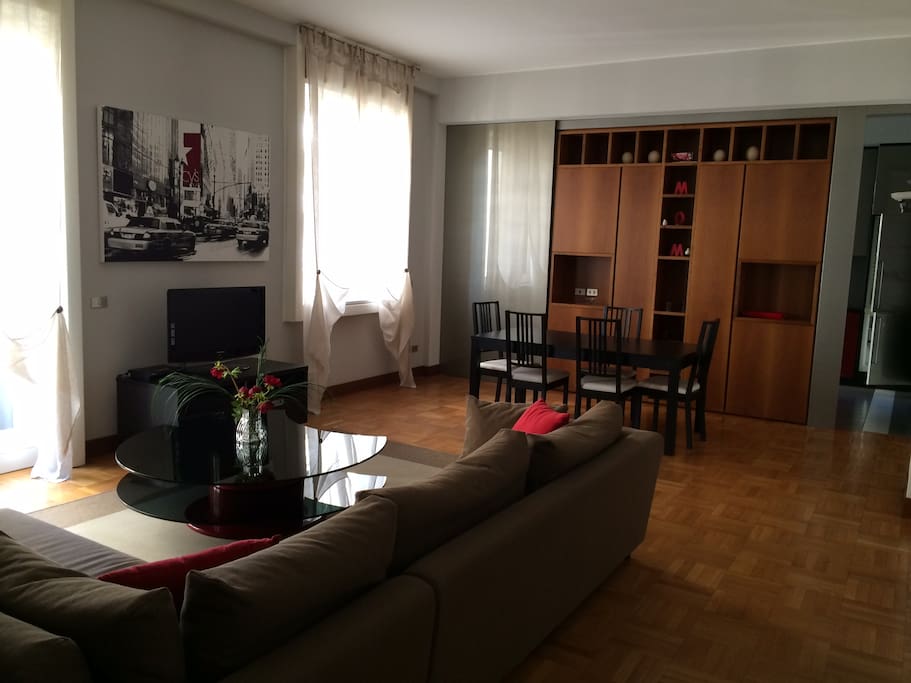 Living room and dining table. The door on the right is the entrance to the kitchen