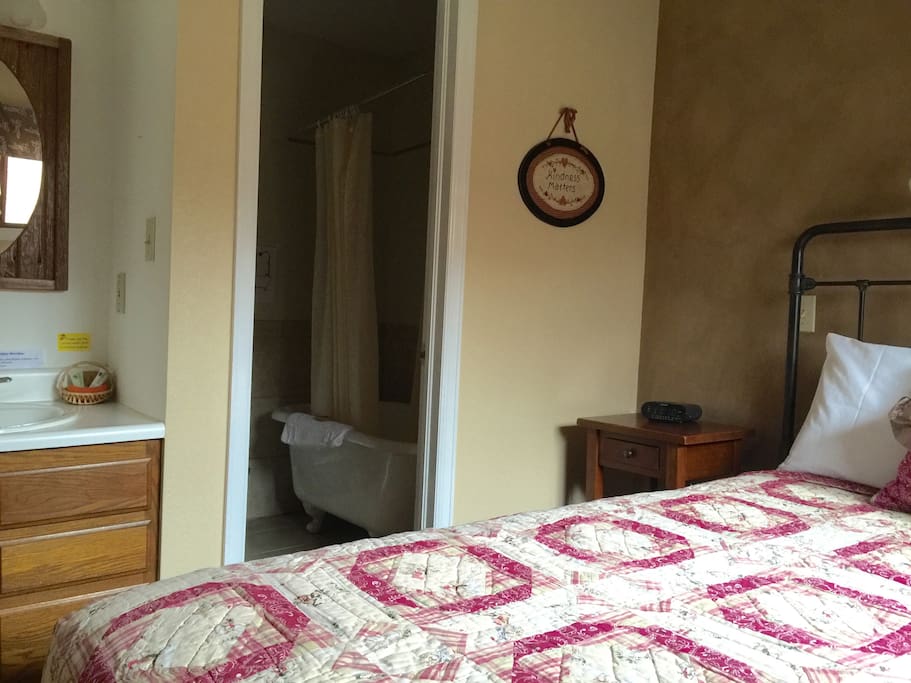 Access to the bathroom from the bedroom. Claw-foot tub. Shower is in the tub.