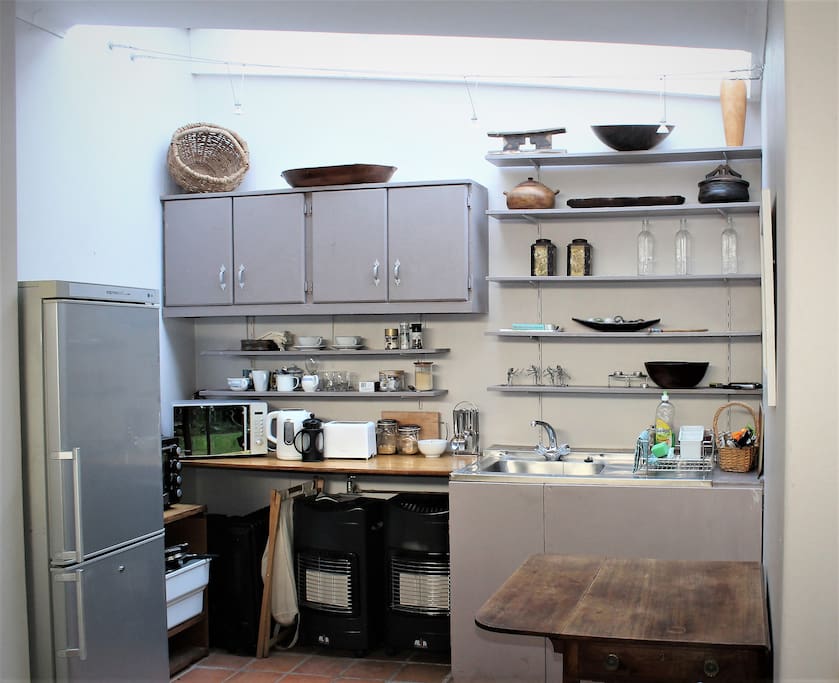 Fully fitted kitchen adjoins bedroom. Microwave, compact stove and oven.
