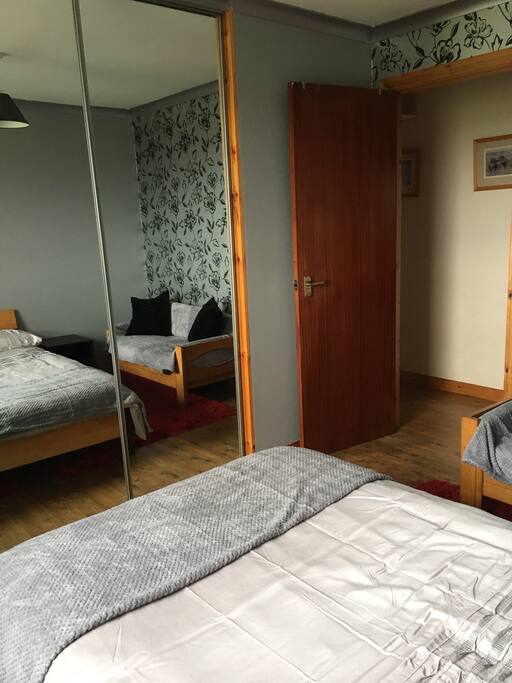 Bedroom with large built in wardrobe. Chest of drawers inside wardrobe.