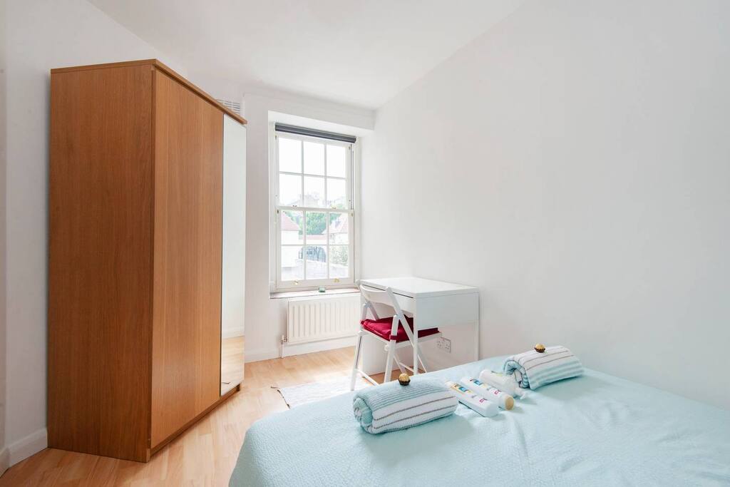 Your small double bedroom with a wardrobe and a desk