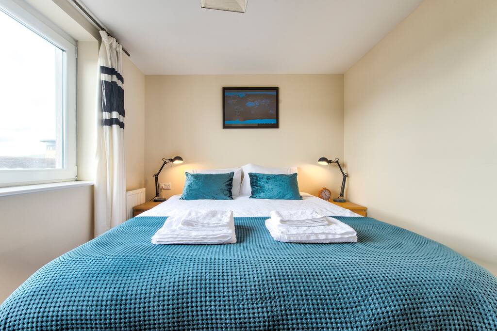 Second bedroom with large European king size bed, built in wardrobe & full length mirror