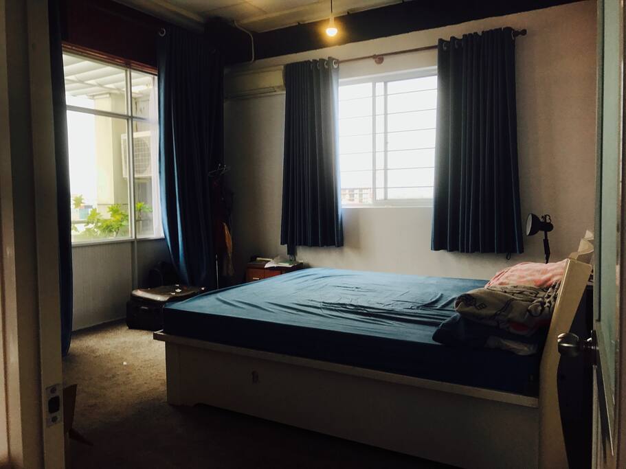 a bedroom with two views, can see the sunrise in the city. 2m bed and air-conditioner. this place is about 8km from the Airport and 10km from the center