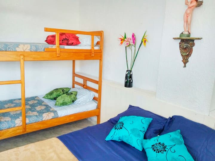 Habitación con cama doble, litera y aire acondicionado. 
Acceso a pequeño balcón.