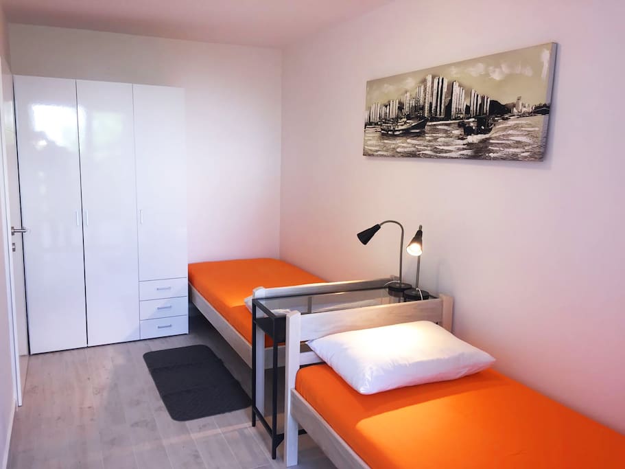 Bedroom with two single beds and balcony.