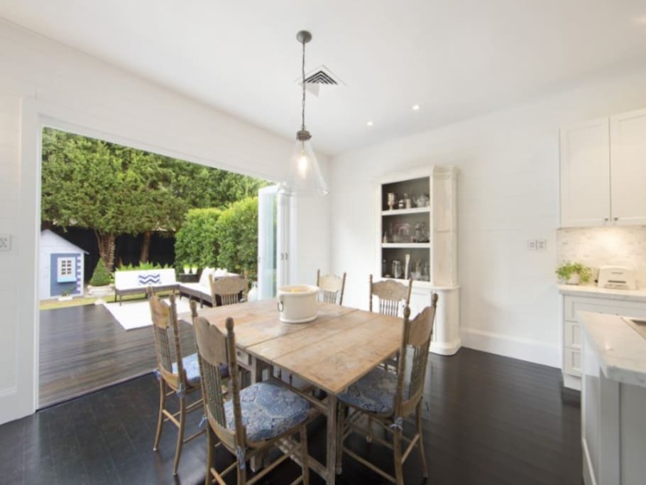 Dining area opening out to backyard with cubby house.