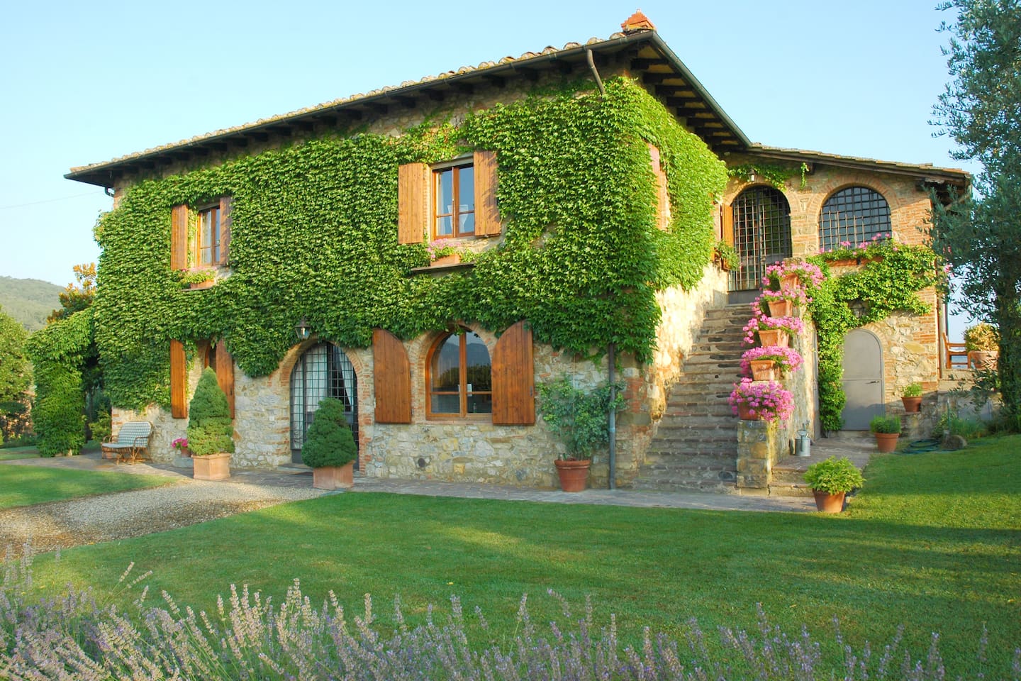 Climbing vines on a Tuscan farmhouse exterior. Come be charmed by Decor Inspiration Under the Tuscan Farmhouse Sun!