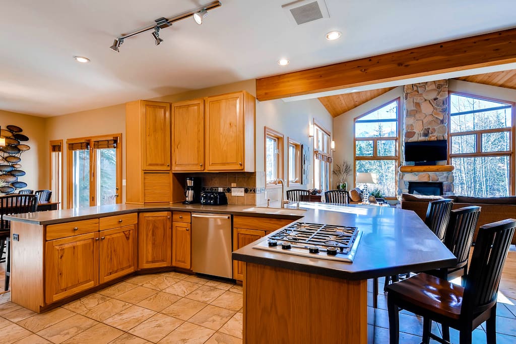 Kitchen with gas cooktop, bar seating and opens into Living Area and Dining - great open floor plan!