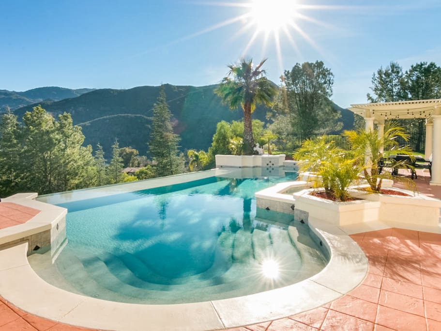 This hillside estate offers breathtaking panoramic valley and mountain views from the private pool.