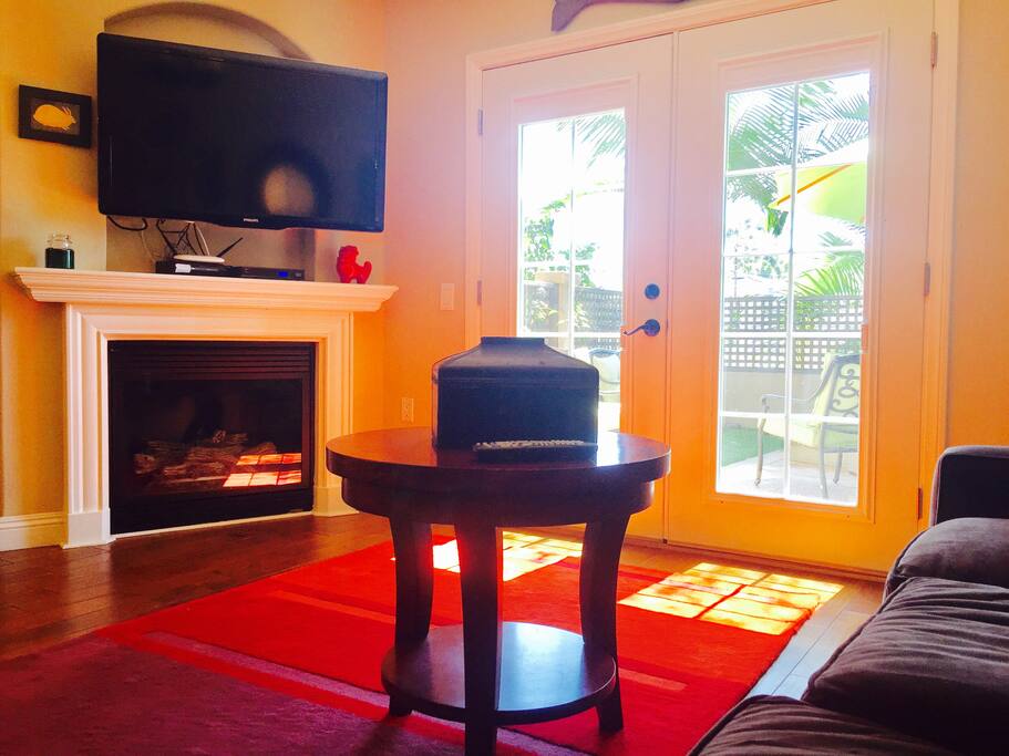 Living room with Flat screen TV, free cable and wifi. Gas fireplace. French doors to private yard.