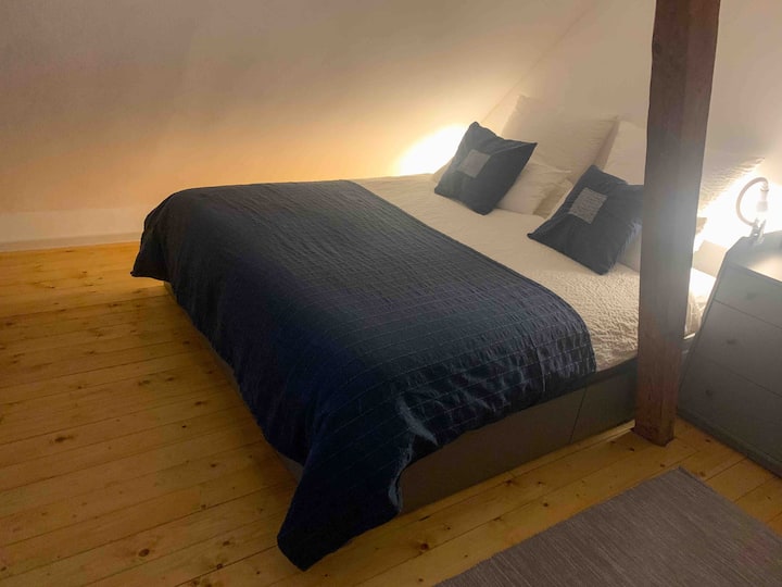 A wide bed with a full mattress for 2 adults 