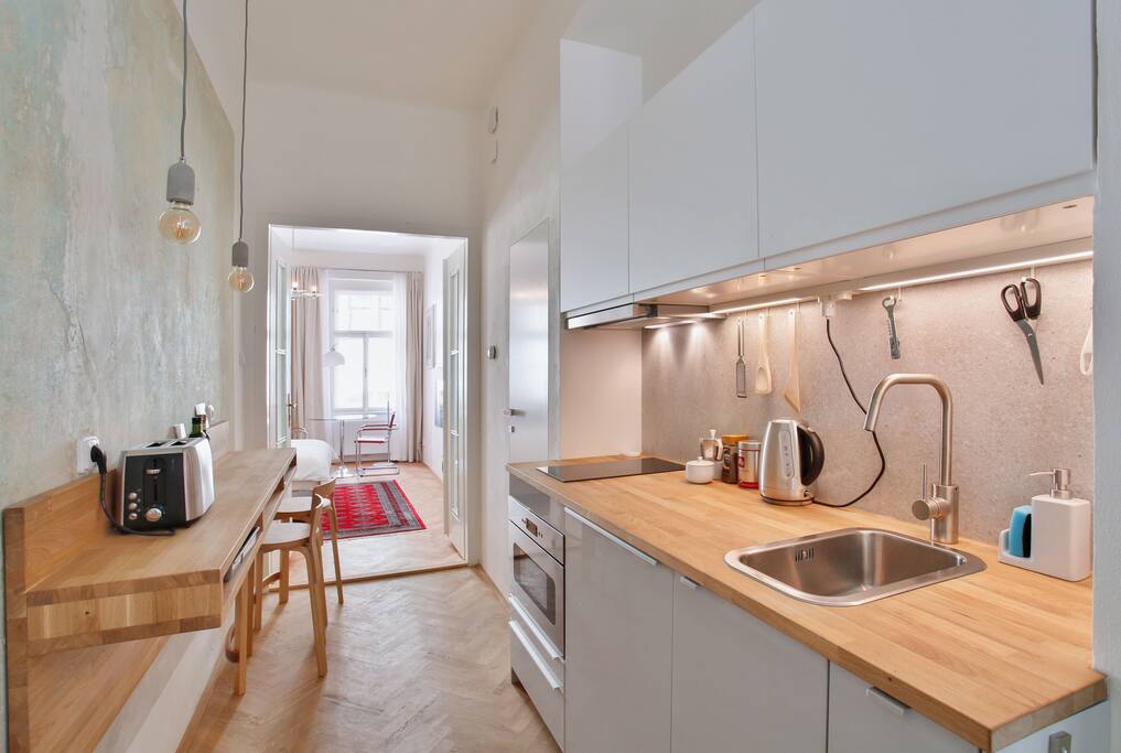 Kitchenette with oak breakfast bar & reproduction 1933 Alvar Aalto stools
