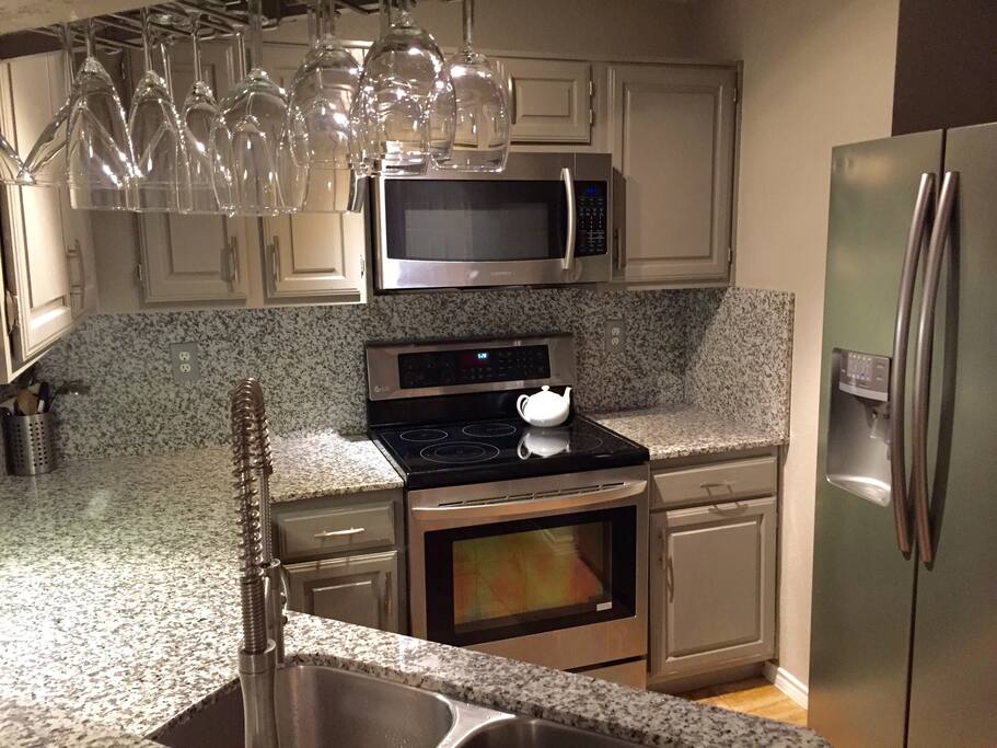 Fully stocked kitchen-stainless appliances and granite countertops.
