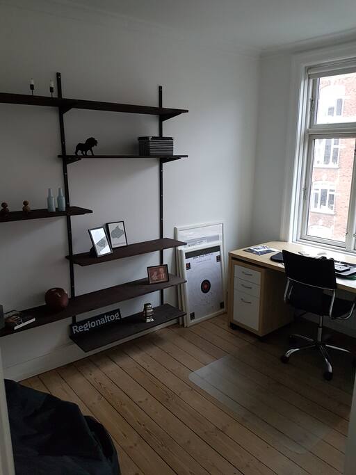 Room with a desk and a fatboy. View to the road. Can be used as a bedroom with an air matress if necessary