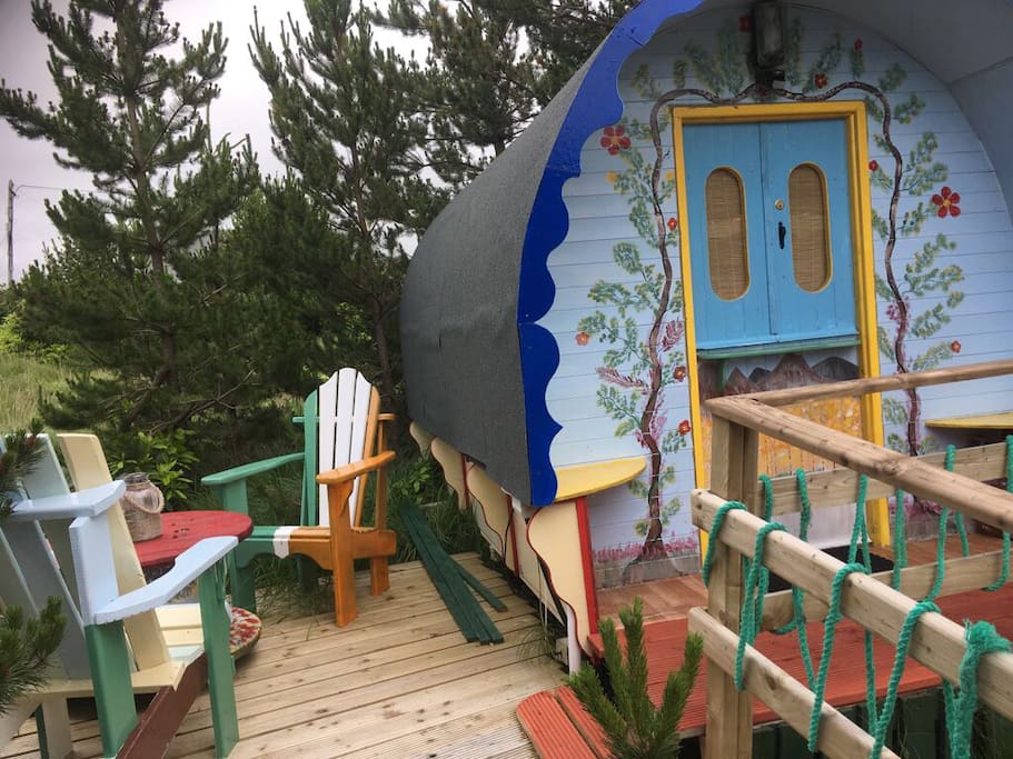 Private table and chairs next to gypsy caravan