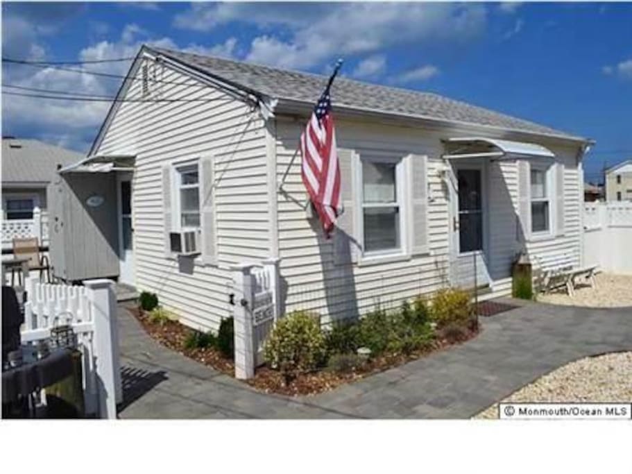 Beach House sits on the back lot of property with a gated outdoor decked area.