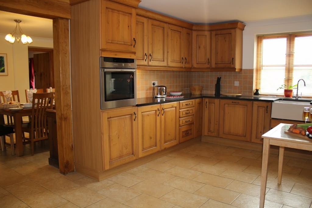Hand fitted oak kitchen with butlers sink and dining room with farmhouse table seats 12