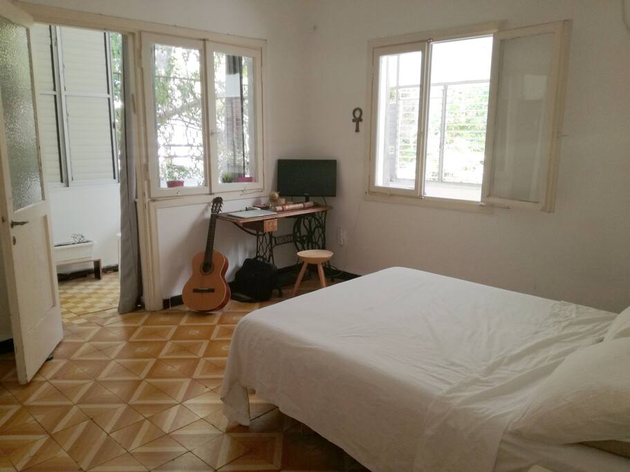 Large bedroom filled with light and an exit to the balcony