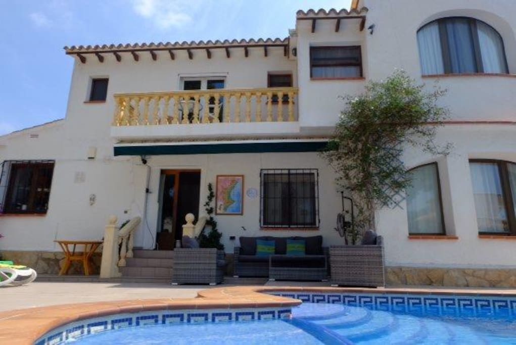 Rear door leading to outdoor lounge and private pool