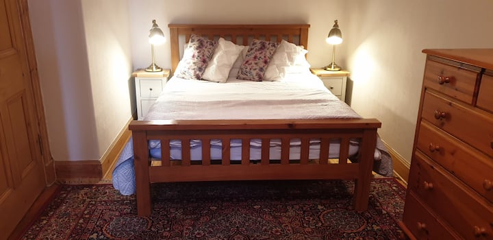The large second bedroom affords ample space for a double and a single bed, in addition to solid pine bedroom furniture.