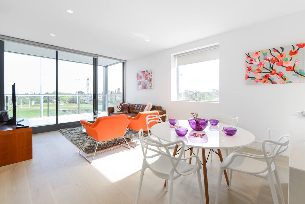The living area views straight out onto a lovely leafy green playing field