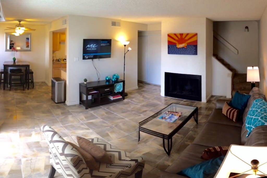 Living room with fireplace. Access to downstairs half bathroom. Patio with sliding door. Kitchen and dining area. Flat screen tv with cable. Internet and wifi available. Stackable Washer and dryer in closet.