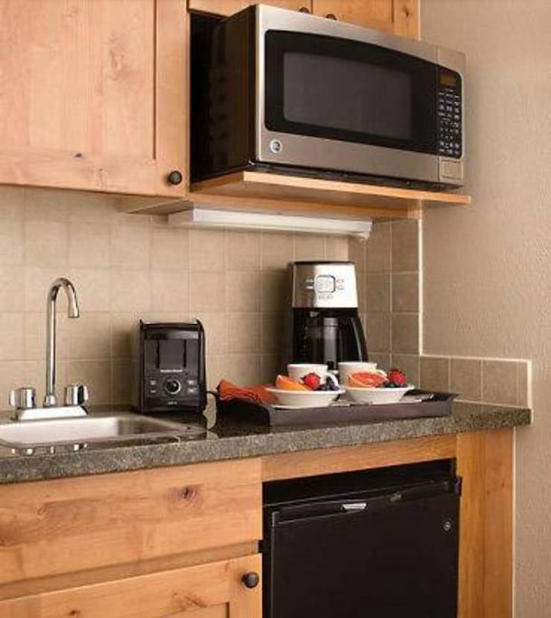 Kitchenette with microwave, mini-fridge, coffee maker, toaster, dishes/utensils