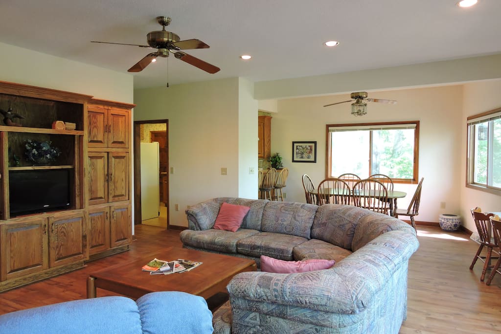 Living room with dining table in background. Table seats 6 and bar seats 3