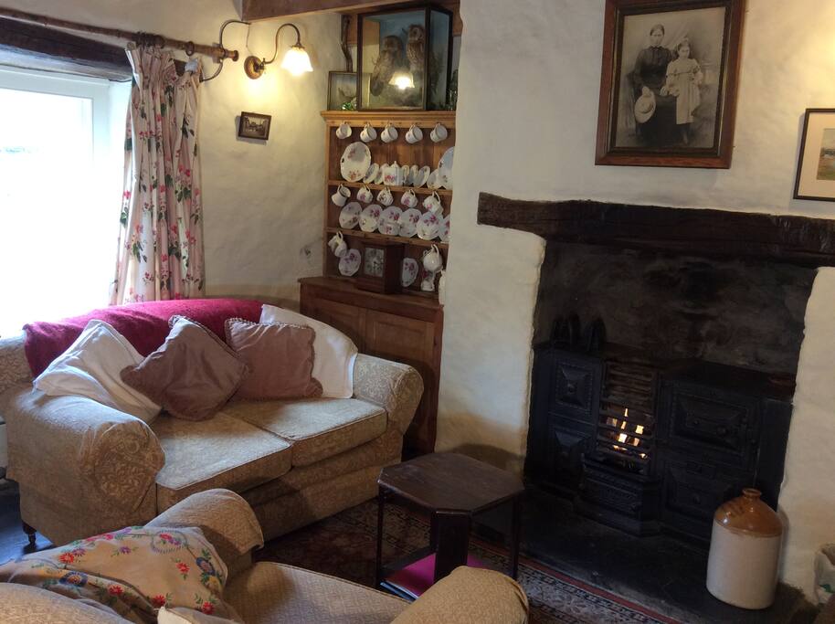Lounge with antique range with gas fire.