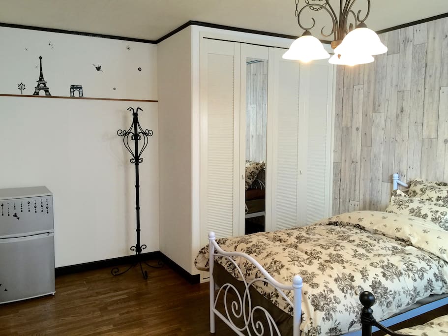 There are iron beds and iron pole hanger. And with wide closed.There is also a refrigerator.