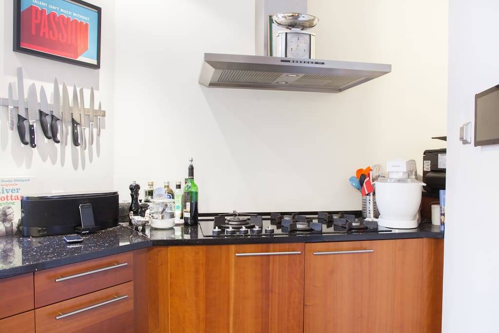 Integrated gas stove with five hobs, stereo with iPhone dock (for the music) to the left and iPad docking system (for the recipes) to the right.