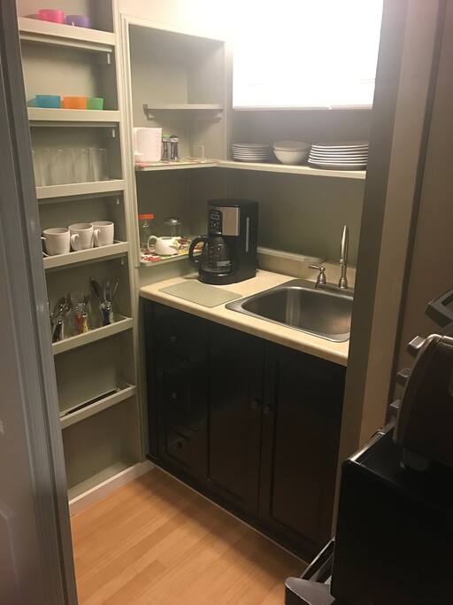 Small kitchenette in the master bedroom; includes microwave, small fridge, and small convection oven
