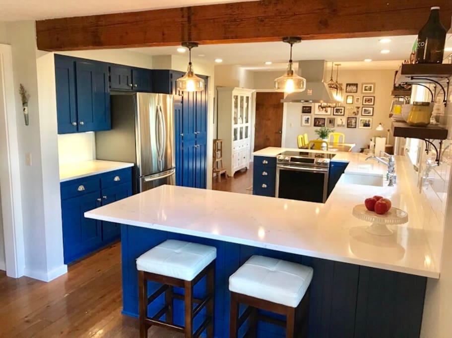 Newly renovated kitchen is the heart of the house; centrally located, with bar seating on both sides, lots of windows, make it a functional , social and bright space.