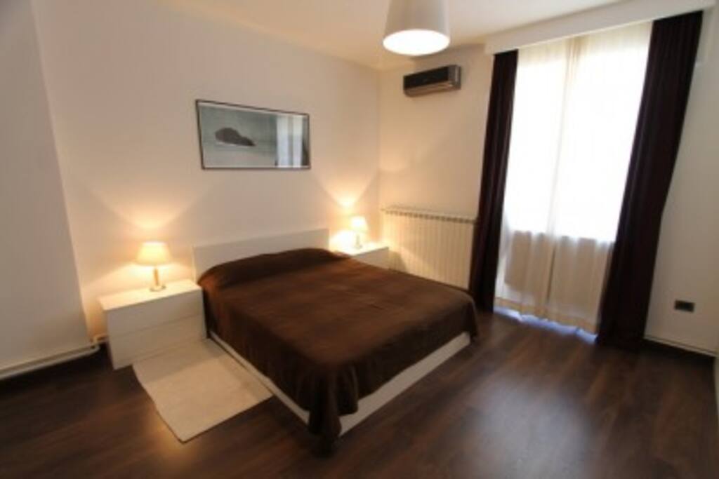 Bedroom full of light with plenty of room and wardrobes.