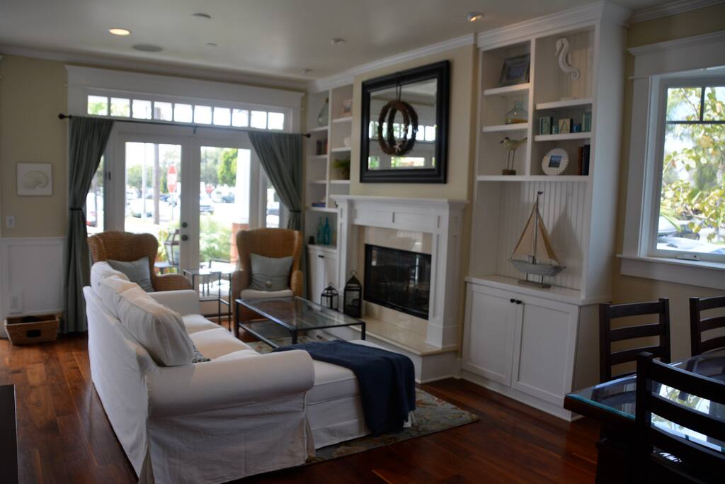 French doors open up to porch and front courtyard that includes a stainless steel gas BBQ.