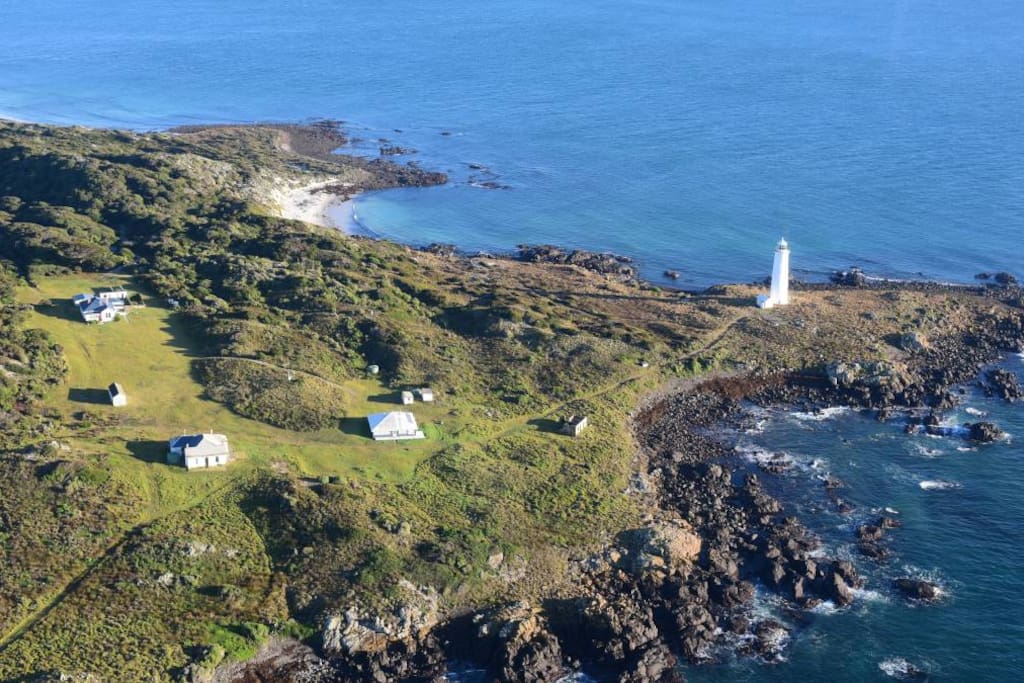 The houses from the sky. The property for rent is the one closest to the lighthouse. The other homes will be empty as you will have the island to yourself.