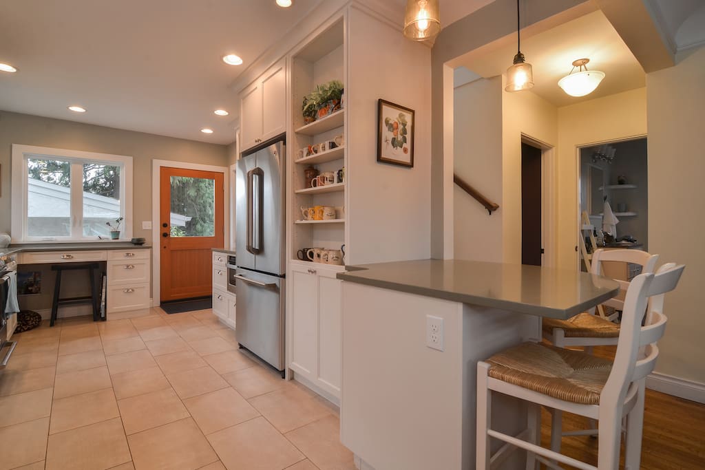 Newly renovated kitchen off the living room with access to backyard and deck