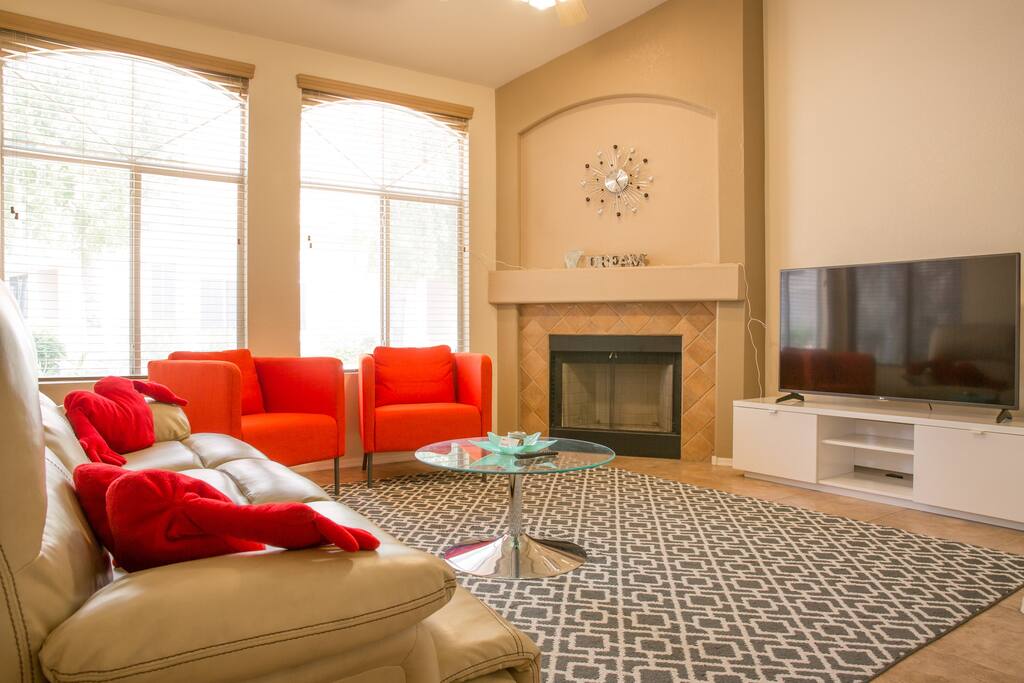 Comfortable living room with large space, a leather recliner sofa, and accent chairs.