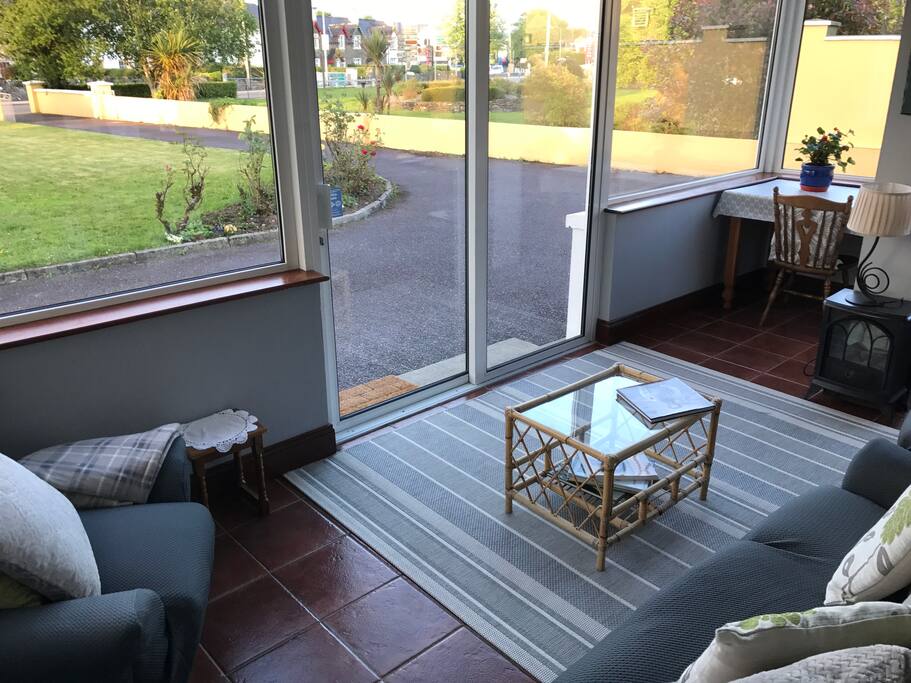 Comfortable conservatory with an abundance of natural light overlooking the spacious garden