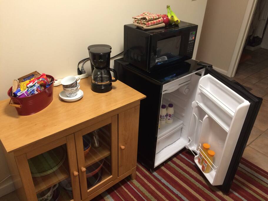 Breakfast bar complete with mini-fridge, microwave, coffee pot and breakfast items.