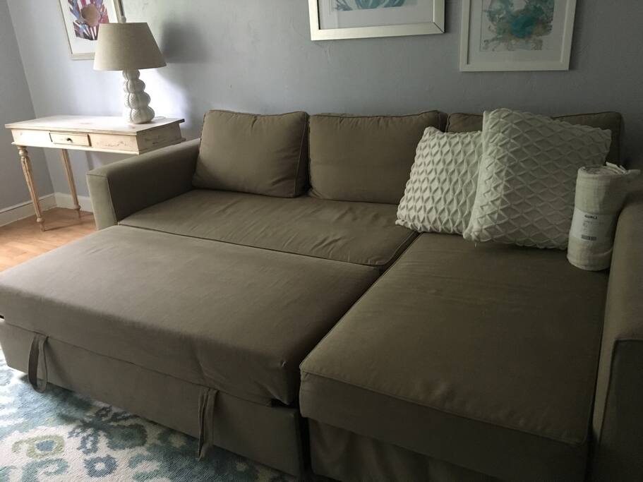 Living room sofa bed with trundle pulled out to sleep
