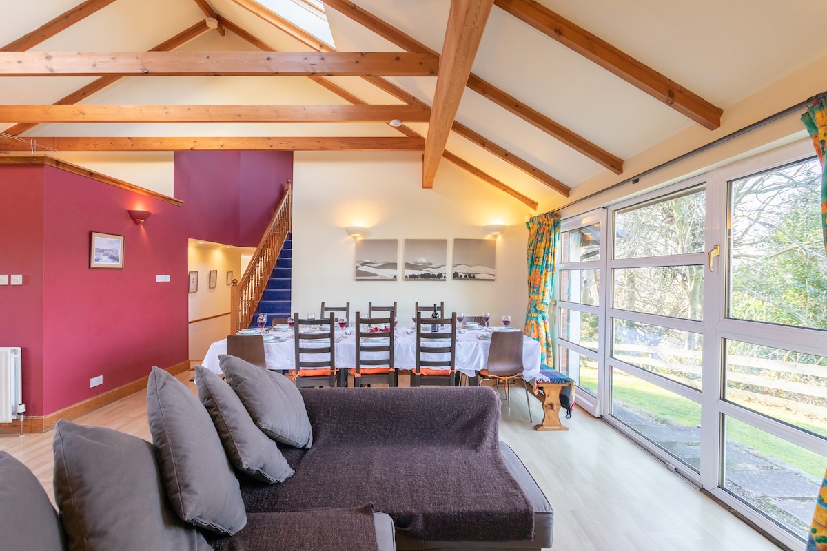 A capacious kitchen-living area with comfy seating for all - ideal for entertaining large groups of friends and family.