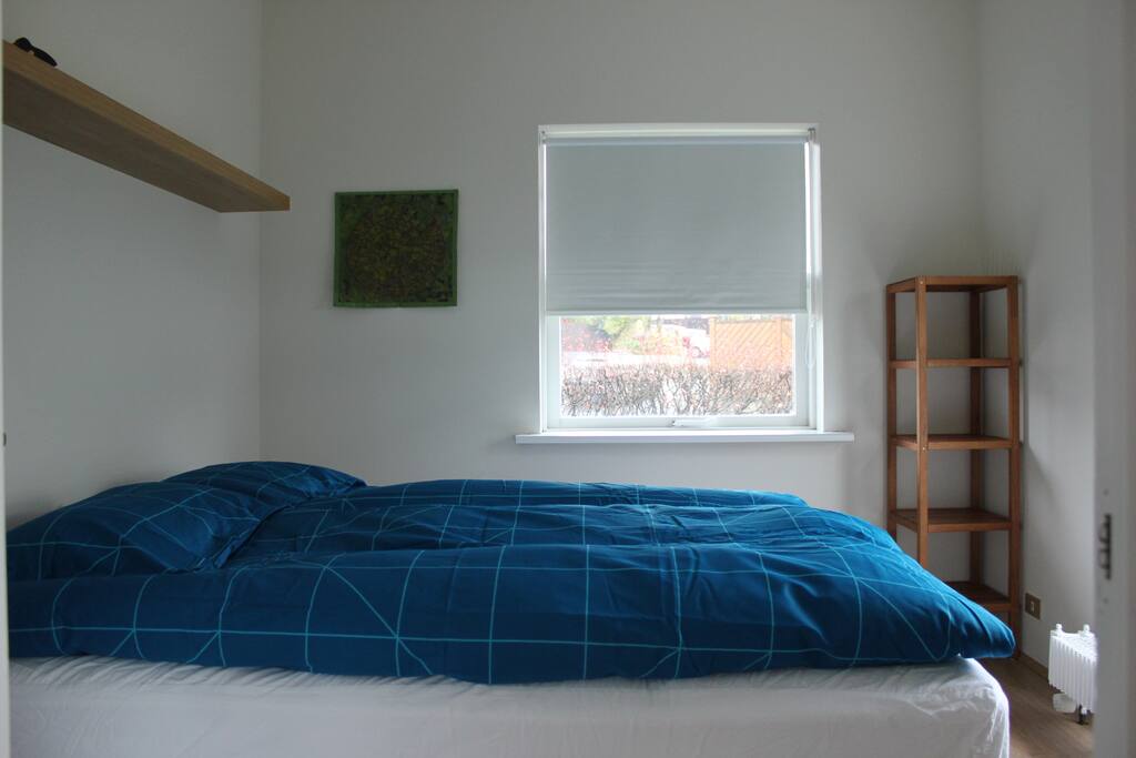 The bigger bedroom with a double bed.