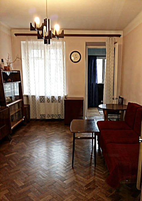 Living room: couch bed, TV, 2 tables, chairs, wardrobe