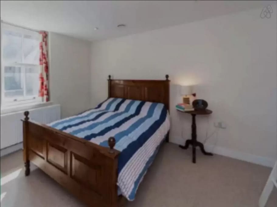 Bedroom One. King size bed, wardrobe and chest of drawers.
