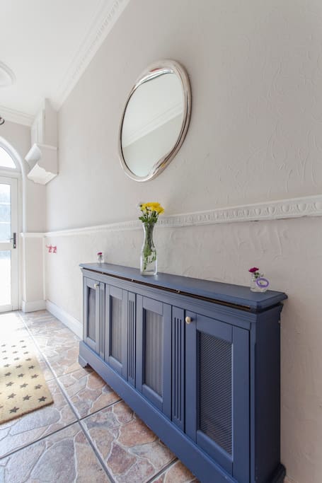 Bright and airy Victorian house entrance.