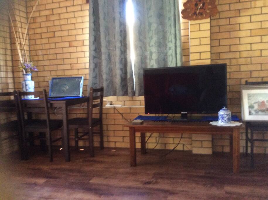 Dining table and TV with DVD player.