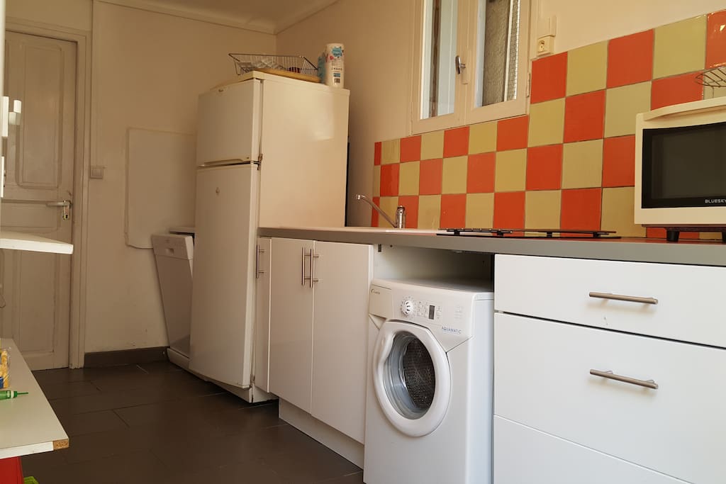 Cuisine équipée avec lave linge, lave vaisselle, 2 plaques vitrocéramiques, four micro-onde, réfrigérateur avec compartiment congélateur, meubles de rangement