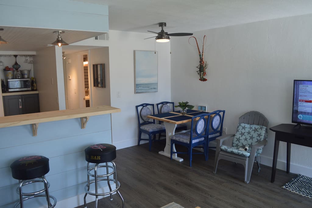 Open concept kitchen and living room keeps the vacation conversation going.
