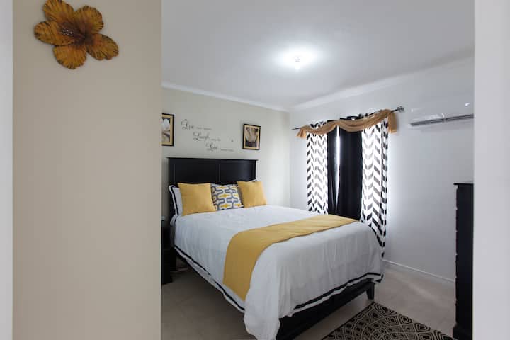 Clean and comfy bedroom with Air Conditioning and a Fan
